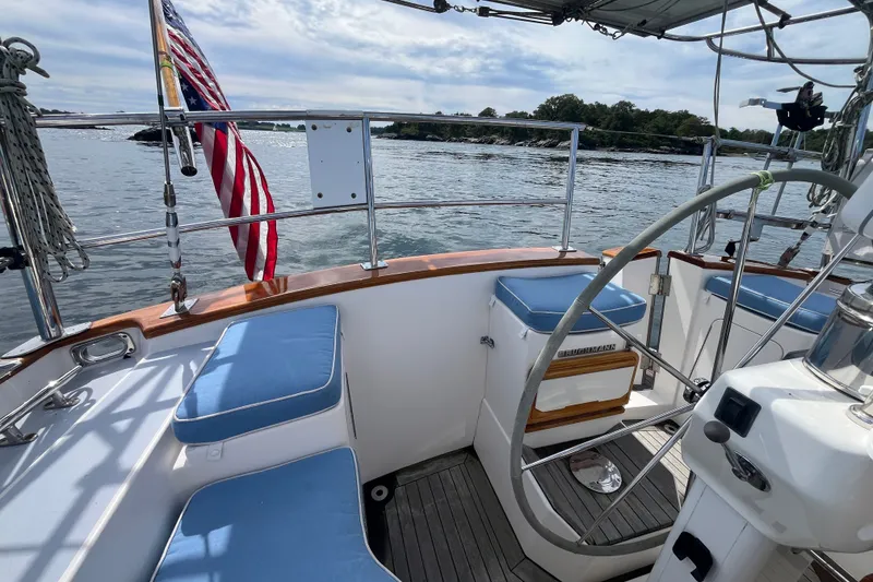 Slide: The Image of Cockpit of 2008 Bruckmann 50 MKII yacht with blue cushions and American flag. - 44