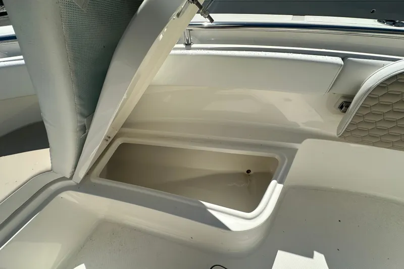Slide: The Image of 2027 Bulls Bay 255 Center Console boat storage compartment open, showcasing interior space. - 11