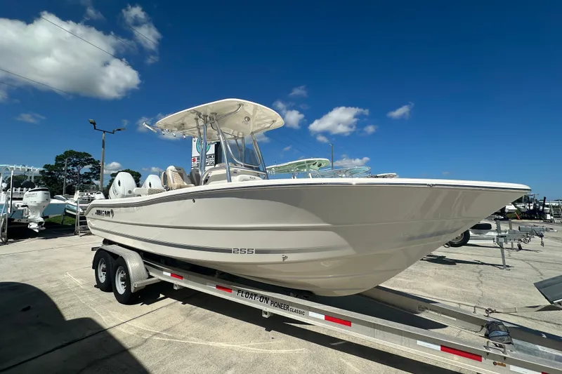 Slide: The Image of 2027 Bulls Bay 255 Center Console boat on trailer under clear blue sky. - 2