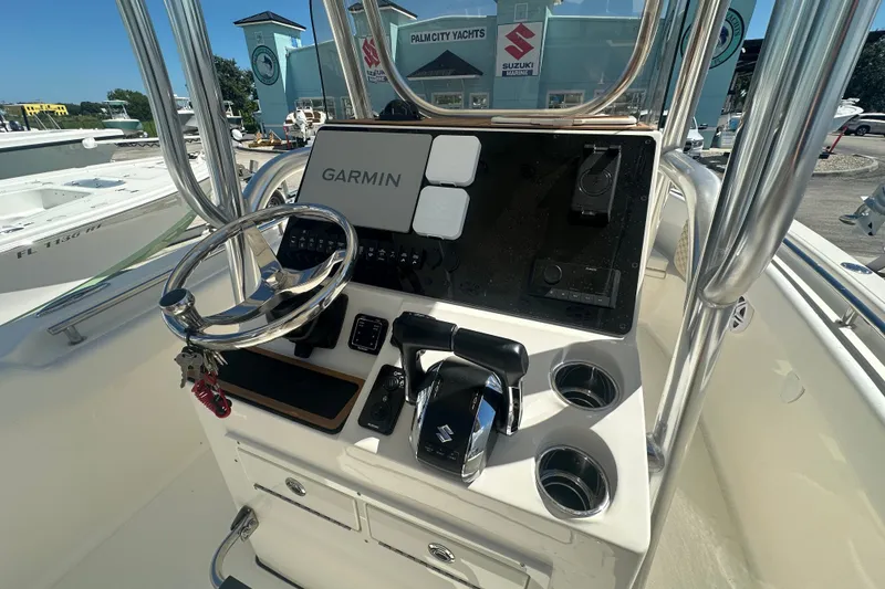 Slide: The Image of 2027 Bulls Bay 255 Center Console boat dashboard with Garmin navigation system and Suzuki controls. - 7