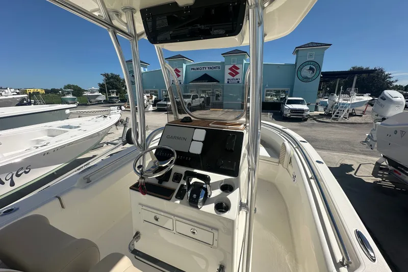 Slide: The Image of 2027 Bulls Bay 255 Center Console boat at a dealership, featuring Garmin navigation. - 6