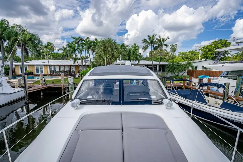 Slide: The Image of 2015 Fairline Targa 48 Open yacht docked, surrounded by palm trees and clear skies. - 36