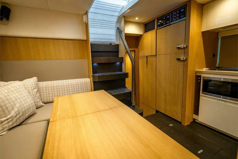 Slide: The Image of Interior of 2015 Fairline Targa 48 Open yacht with modern wood finishes and seating area. - 16