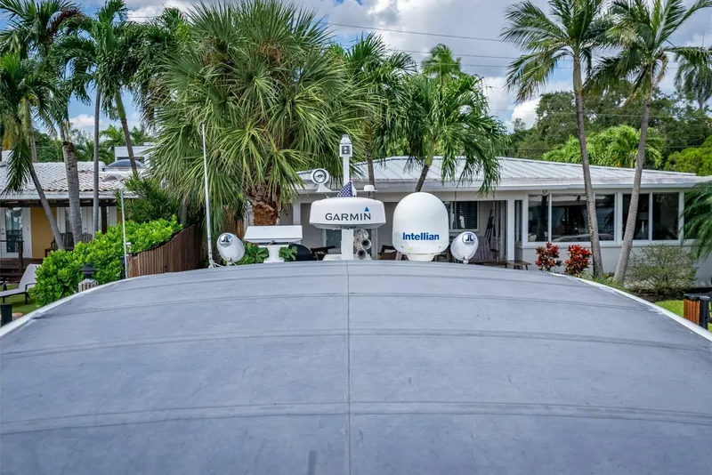 Slide: The Image of 2015 Fairline Targa 48 Open yacht with Garmin and Intellian equipment, surrounded by palm trees. - 37