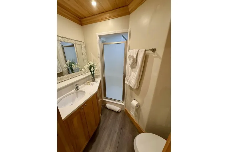 Slide: The Image of Luxurious catamaran bathroom with wooden accents, elegant vanity, and shower. - 29
