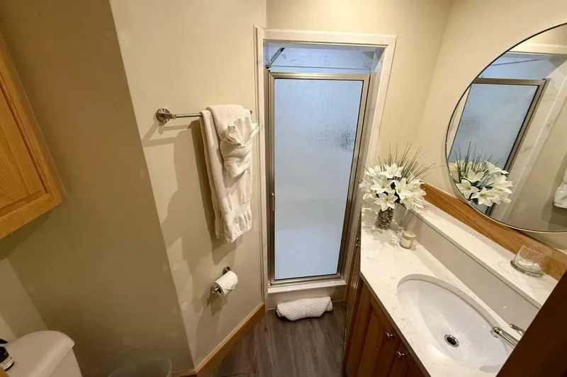 Slide: The Image of Luxurious catamaran bathroom with modern fixtures, round mirror, and elegant floral decor. - 34