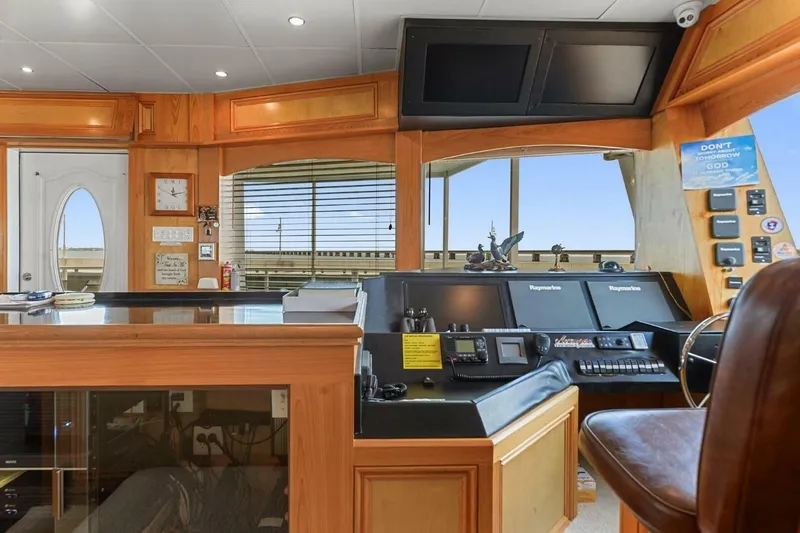 Slide: The Image of Luxurious 2018 Avenger Custom Catamaran interior with advanced navigation controls and wood paneling. - 14