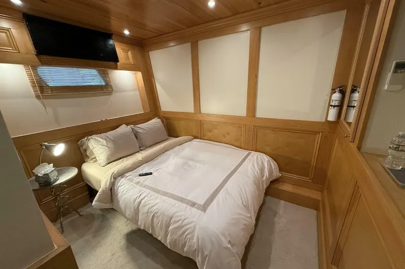 Slide: The Image of Luxurious bedroom interior of 2018 Avenger Custom Catamaran, featuring cozy bed and elegant wood paneling. - 31