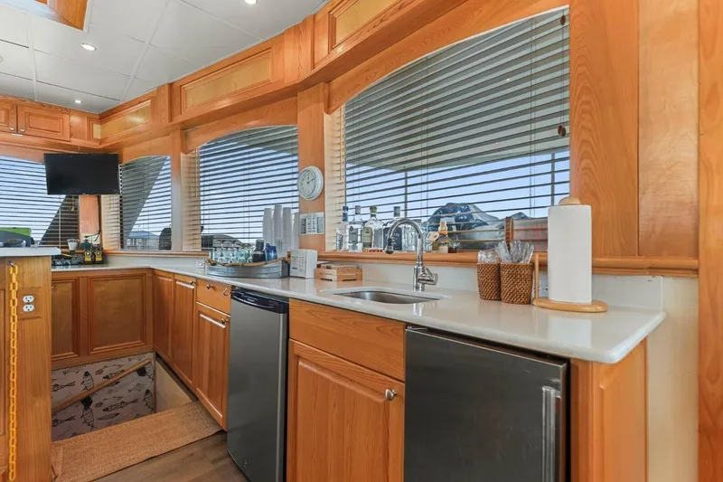 Slide: The Image of Luxurious kitchen interior of 2018 Avenger Custom Catamaran with wooden cabinetry and modern appliances. - 16