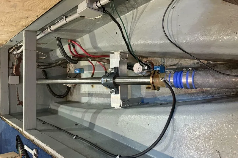 Slide: The Image of Engine compartment of 2018 Avenger Custom Luxury Catamaran Coastal Cruiser, showing mechanical components and wiring. - 41