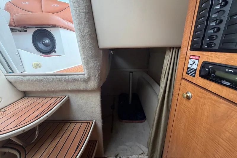 Slide: The Image of 2003 Maxum 2900 SE cabin interior with wood paneling and audio system. - 83