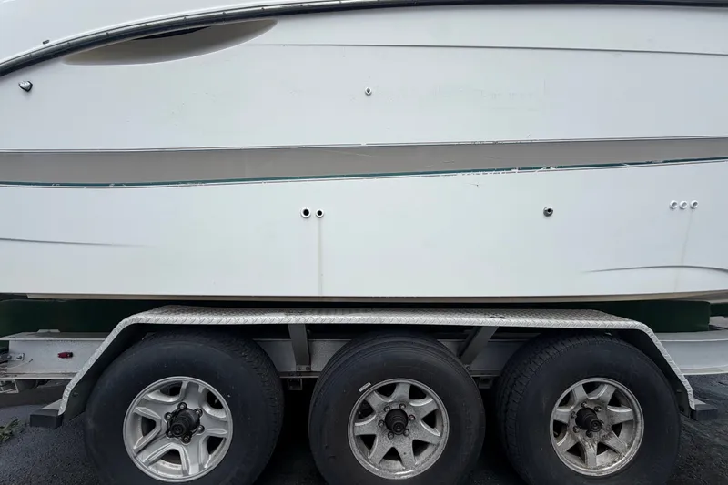 Slide: The Image of 2003 Maxum 2900 SE boat on trailer with triple axle wheels. - 98