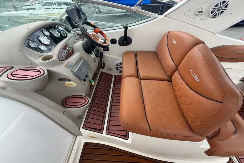 Slide: The Image of 2003 Maxum 2900 SE boat interior with brown leather seats and control panel. - 31