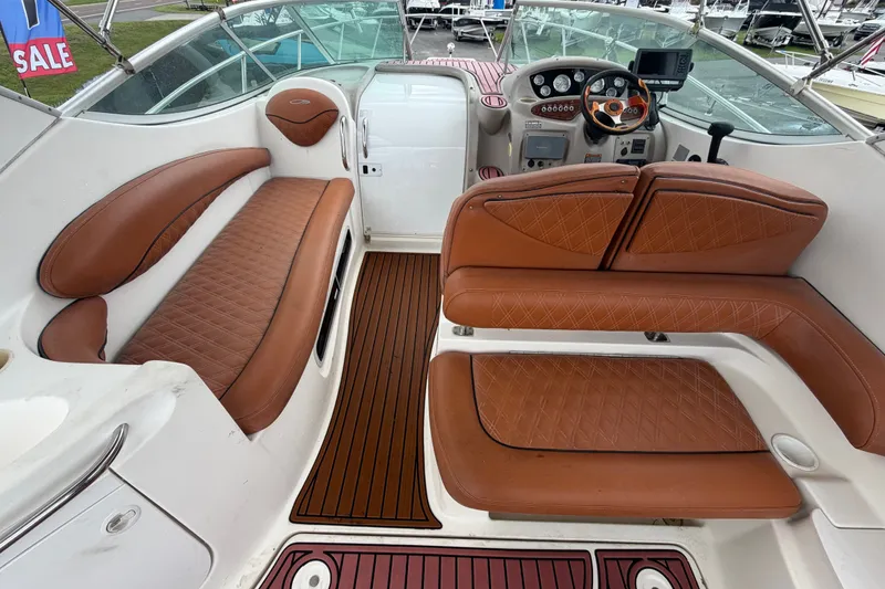 Slide: The Image of 2003 Maxum 2900 SE boat interior with brown leather seating and modern dashboard. - 27