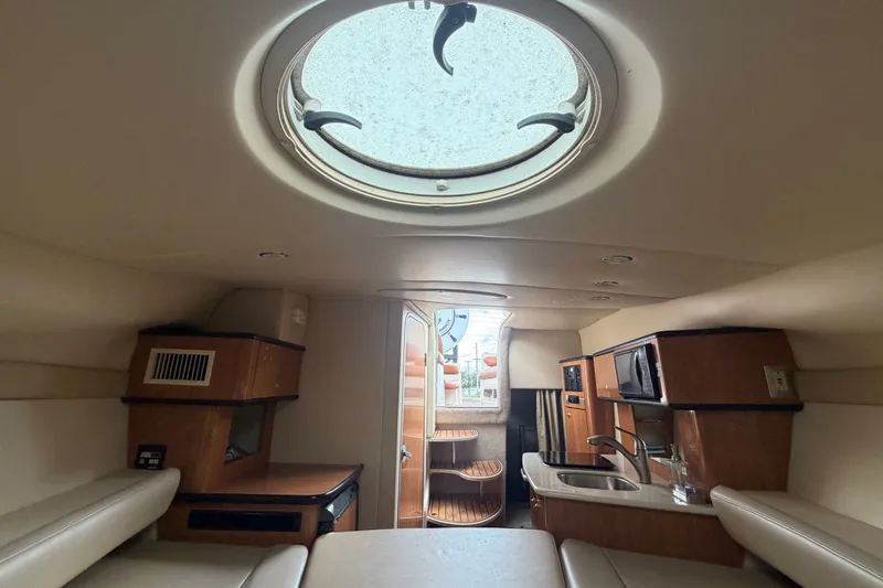 Slide: The Image of Interior of 2003 Maxum 2900 SE boat with kitchenette and seating area. - 69