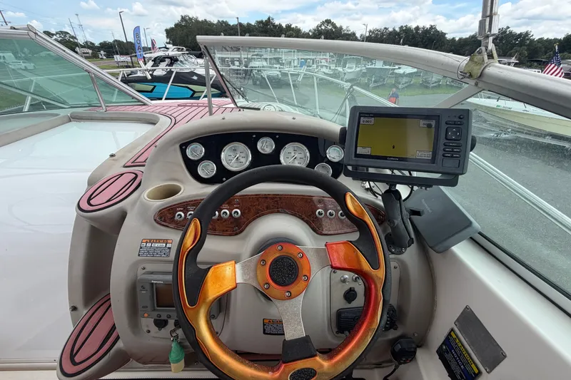 Slide: The Image of 2003 Maxum 2900 SE boat dashboard with steering wheel and navigation system. - 35