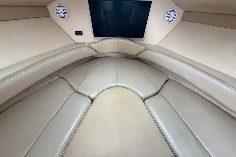 Slide: The Image of 2003 Maxum 2900 SE boat interior with beige seating and mounted speakers. - 67