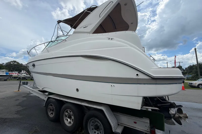 Slide: The Image of 2003 Maxum 2900 SE boat on trailer under cloudy sky. - 10