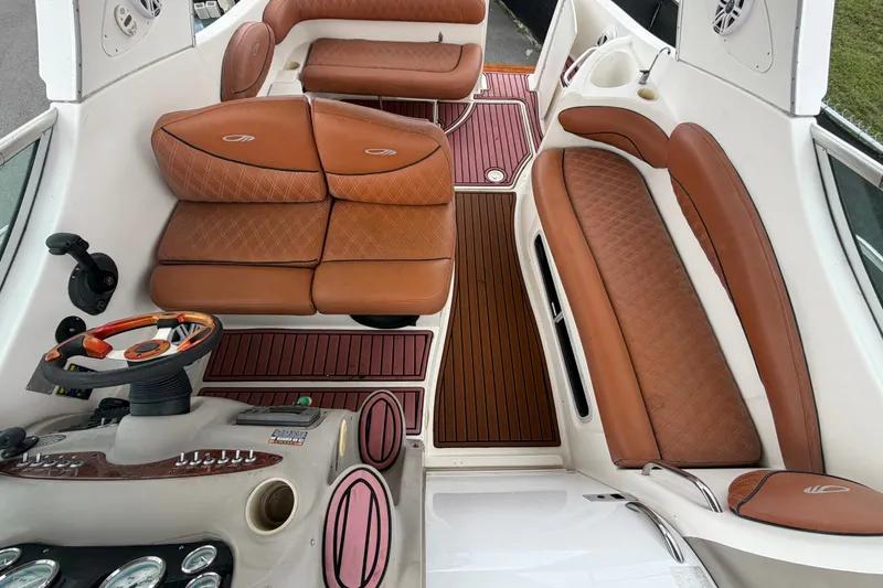 Slide: The Image of 2003 Maxum 2900 SE boat interior with brown leather seating and wood accents. - 50