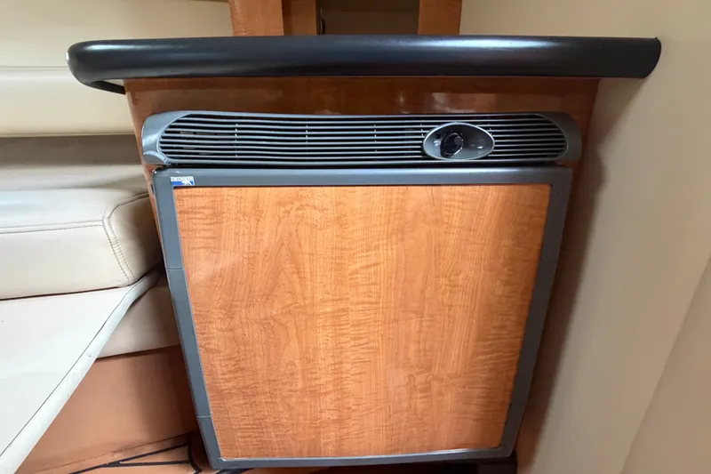 Slide: The Image of 2003 Maxum 2900 SE boat interior with wood-paneled mini fridge. - 74