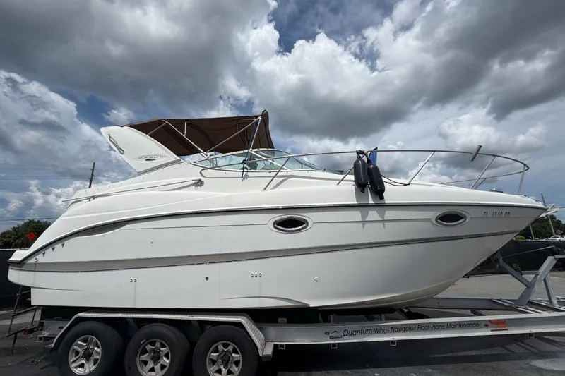 Slide: The Image of 2003 Maxum 2900 SE boat on trailer under cloudy sky. - 1