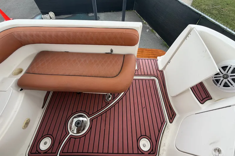 Slide: The Image of 2003 Maxum 2900 SE boat interior with brown seating and red flooring. - 90