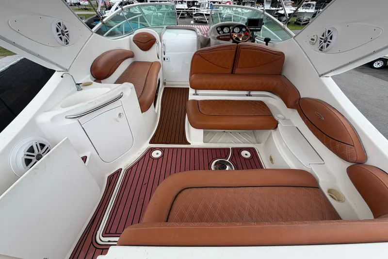 Slide: The Image of 2003 Maxum 2900 SE boat interior with brown leather seating and white cabinetry. - 18