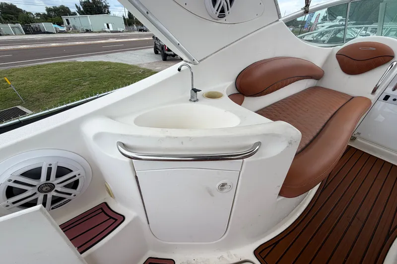 Slide: The Image of 2003 Maxum 2900 SE boat interior with sink, seating, and speaker. - 20