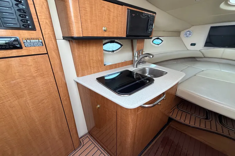 Slide: The Image of 2003 Maxum 2900 SE boat interior with kitchenette and seating area. - 59