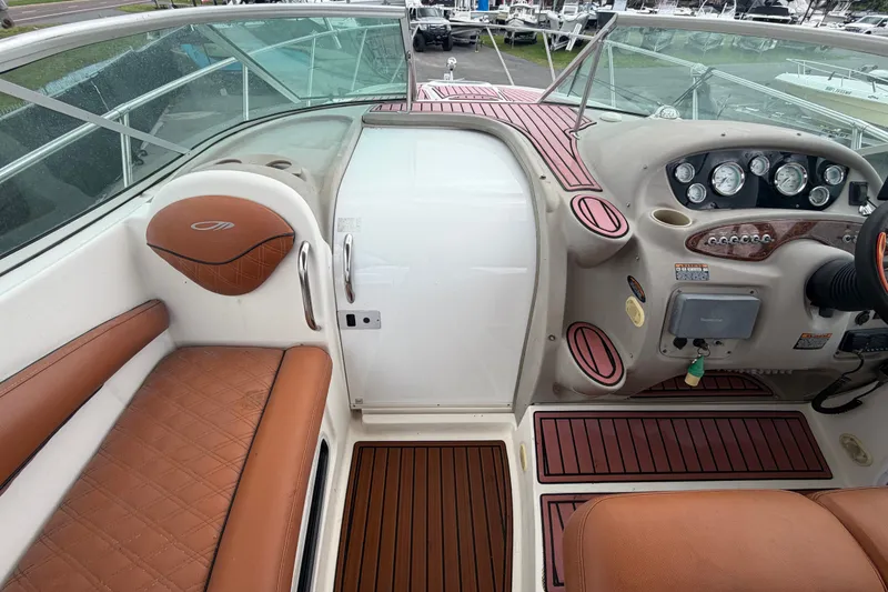 Slide: The Image of 2003 Maxum 2900 SE boat cockpit with brown leather seating and control panel. - 30