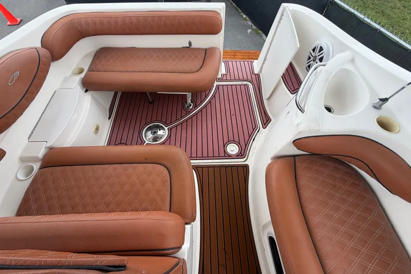 Slide: The Image of 2003 Maxum 2900 SE boat interior with brown leather seating and wood-style flooring. - 88