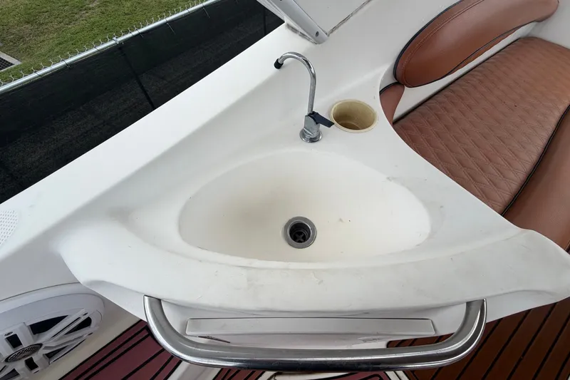 Slide: The Image of The image shows a sink on a boat with a faucet and brown seats nearby. - 22
