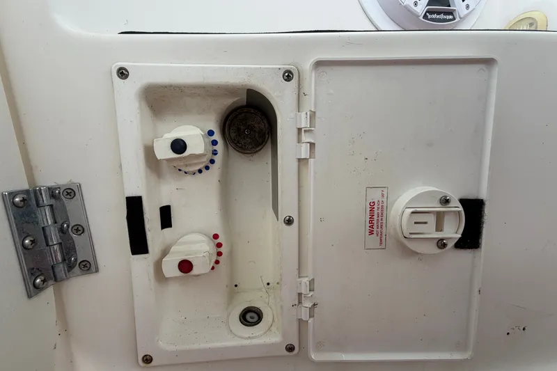 Slide: The Image of Control panel of a 2003 Maxum 2900 SE boat with knobs and warning label. - 93