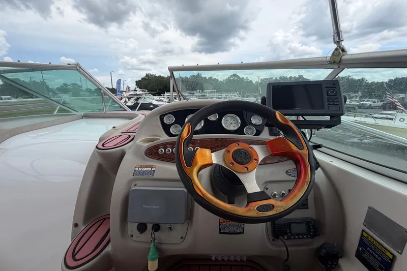 Slide: The Image of 2003 Maxum 2900 SE boat dashboard with steering wheel and navigation equipment. - 34