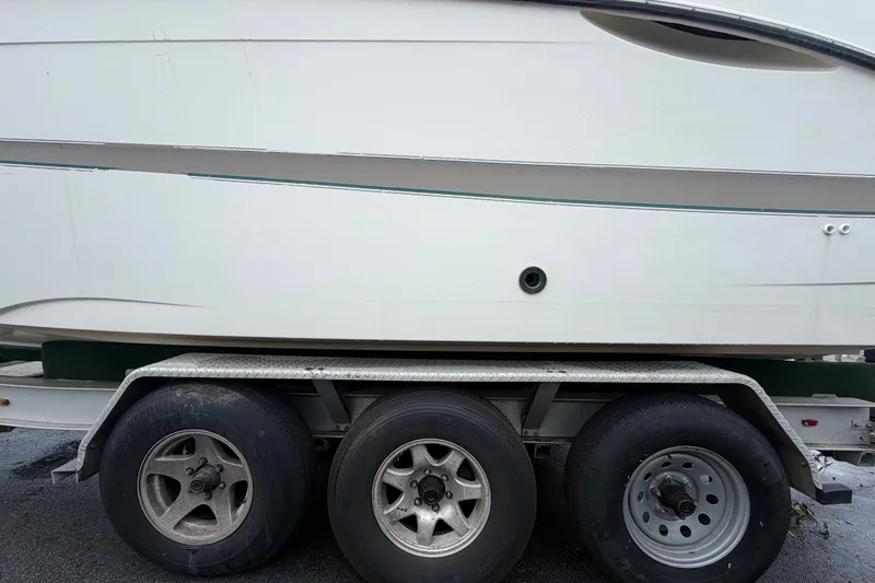 Slide: The Image of 2003 Maxum 2900 SE boat on a triple-axle trailer, side view. - 97