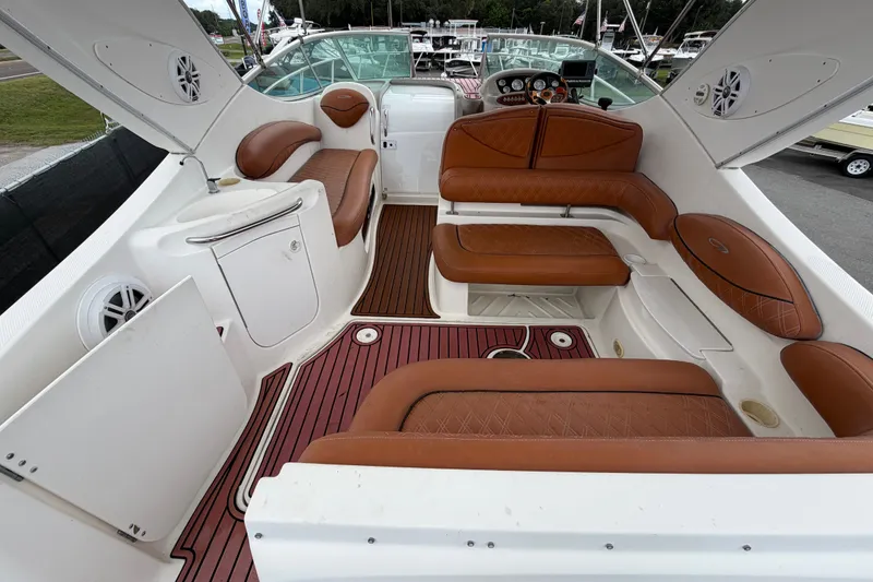 Slide: The Image of 2003 Maxum 2900 SE boat interior with brown leather seating and white cabinetry. - 15
