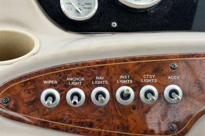 Slide: The Image of Dashboard switches on a 2003 Maxum 2900 SE boat, featuring various light controls. - 38