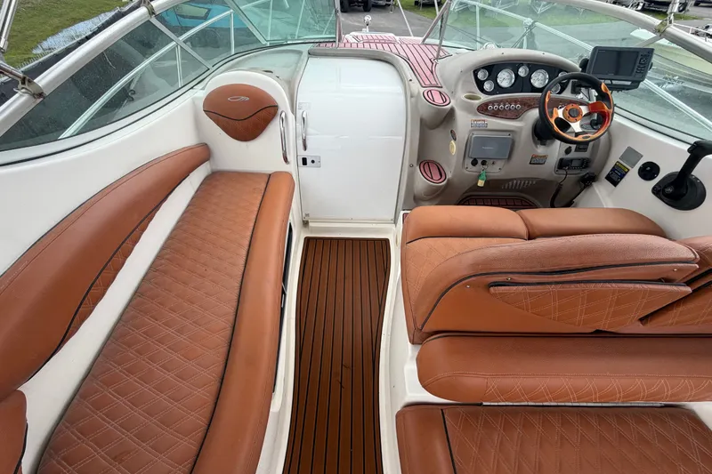 Slide: The Image of 2003 Maxum 2900 SE boat interior with brown leather seating and modern dashboard. - 28