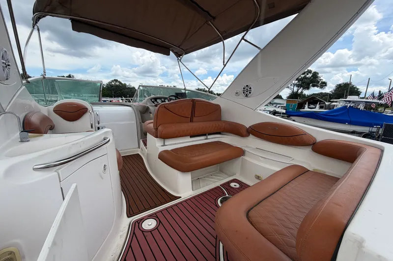 Slide: The Image of 2003 Maxum 2900 SE boat interior with brown leather seating and wood flooring. - 19