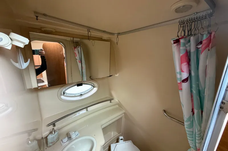 Slide: The Image of Bathroom interior of 2003 Maxum 2900 SE boat with shower and mirror. - 78
