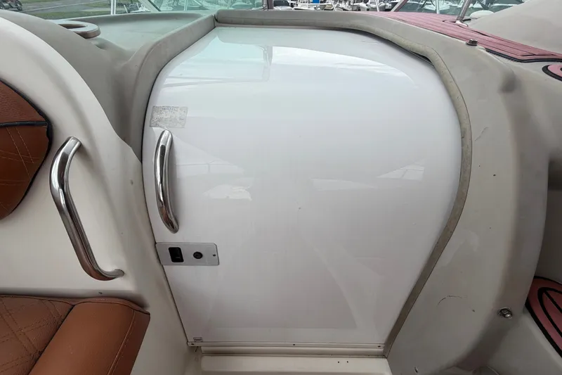 Slide: The Image of 2003 Maxum 2900 SE boat interior with white cabin door and brown seating. - 51