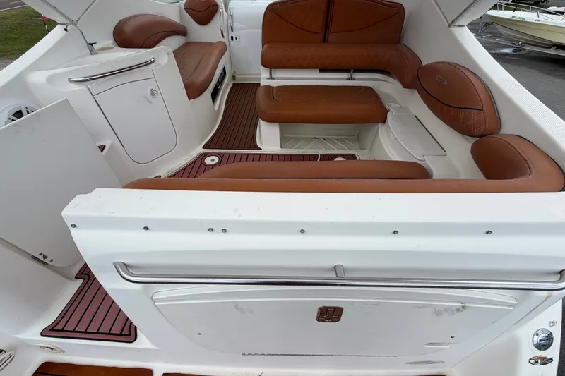 Slide: The Image of 2003 Maxum 2900 SE boat interior with brown leather seating and white cabinetry. - 16