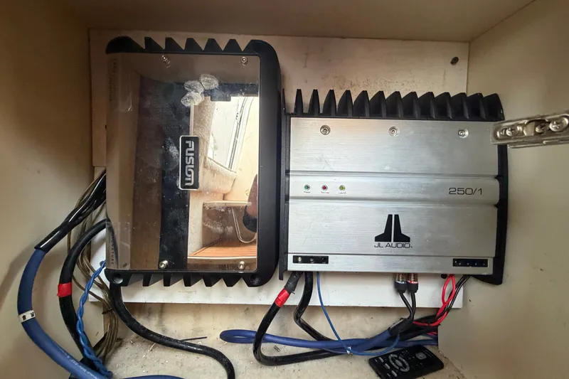 Slide: The Image of Audio amplifiers in a 2003 Maxum 2900 SE boat, featuring Fusion and JL Audio equipment. - 57
