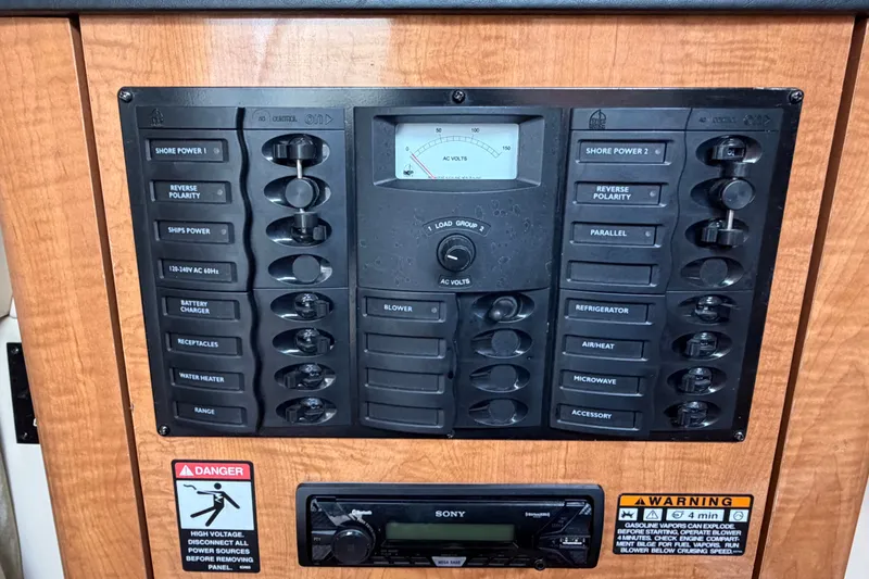 Slide: The Image of Electrical control panel on a 2003 Maxum 2900 SE boat, featuring various switches and warnings. - 55
