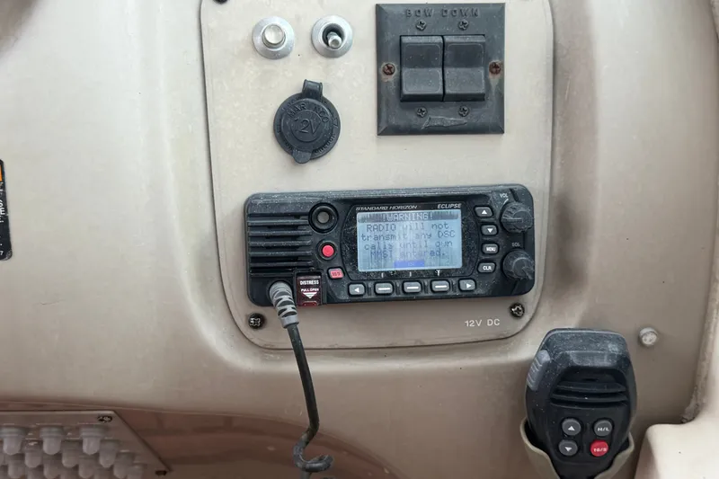Slide: The Image of Control panel of a 2003 Maxum 2900 SE boat with radio and switches. - 41