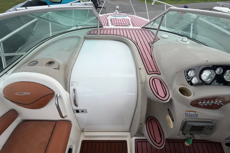 Slide: The Image of 2003 Maxum 2900 SE boat cockpit with brown seating and modern dashboard controls. - 43
