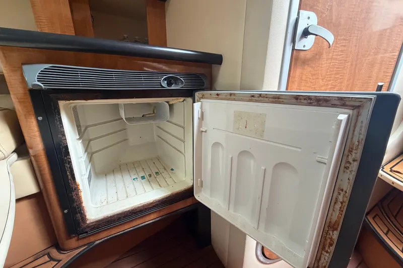 Slide: The Image of Open refrigerator inside a 2003 Maxum 2900 SE boat cabin. - 75