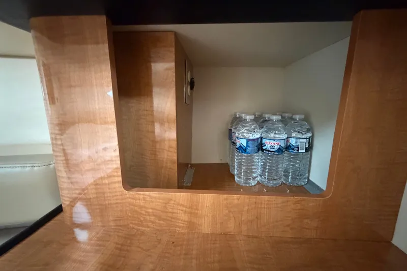 Slide: The Image of Wooden cabinet in 2003 Maxum 2900 SE boat with bottled water storage. - 73