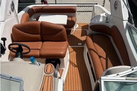 Slide: The Image of 2003 Maxum 2900 SE boat interior with brown leather seating and wooden flooring. - 1