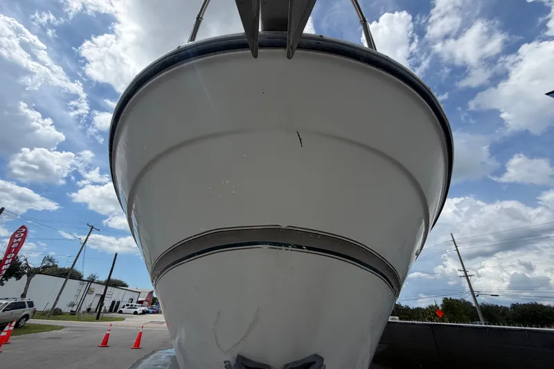 Slide: The Image of Front view of a 2003 Maxum 2900 SE boat under a cloudy sky. - 14